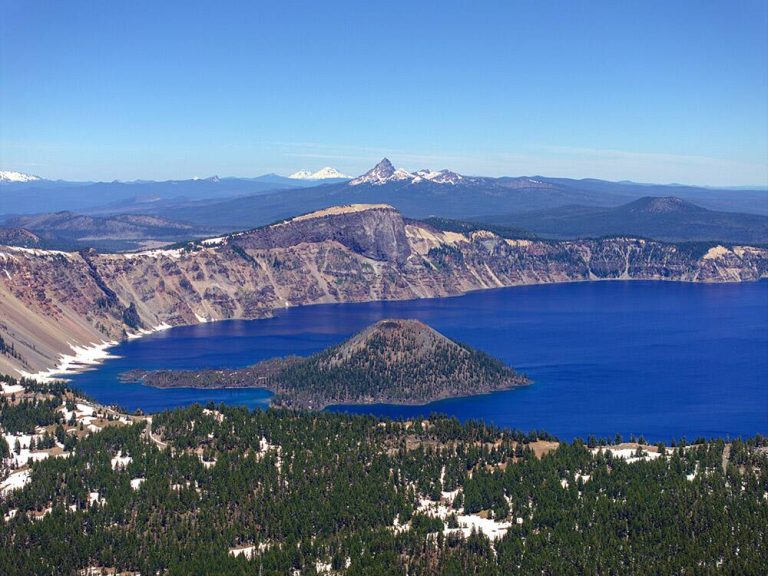 Aerial view of Crater Lake with snowcapped mountain peaks